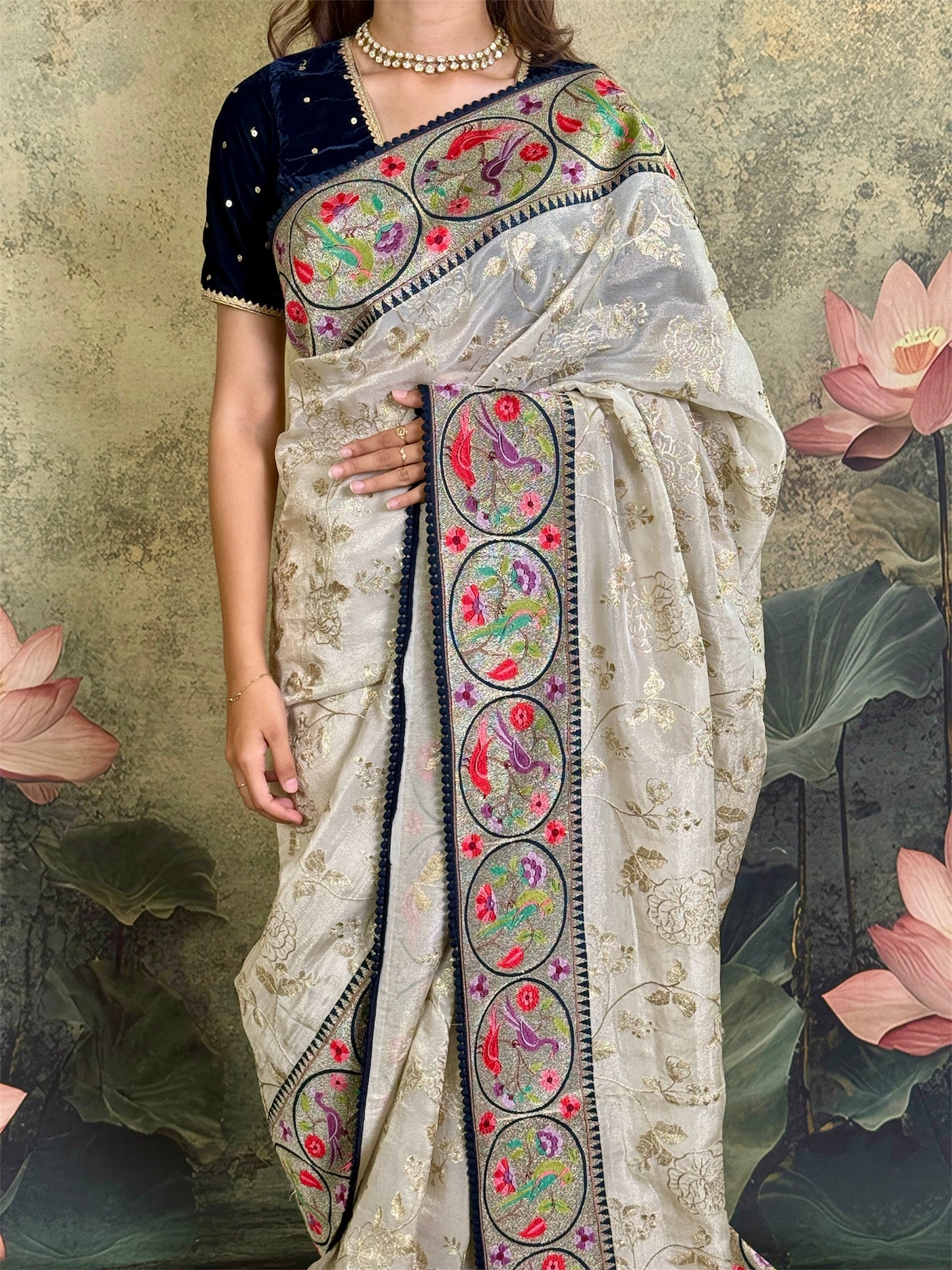 Pure tissue silk saree with zari work and contrast fusion blouse and border.