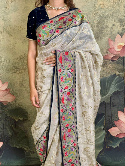 Pure tissue silk saree with zari work and contrast fusion blouse and border.