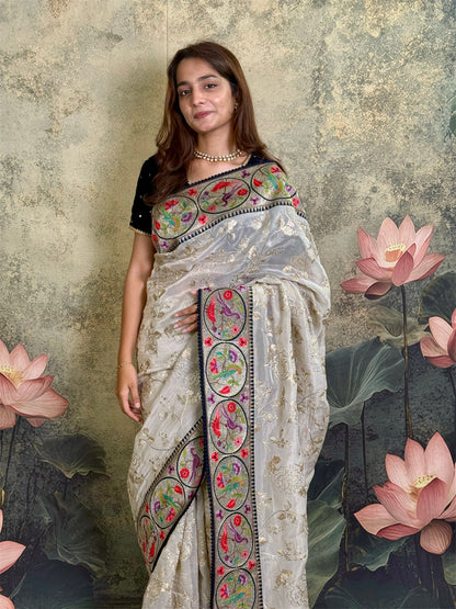 Pure tissue silk saree with zari work and contrast fusion blouse and border.