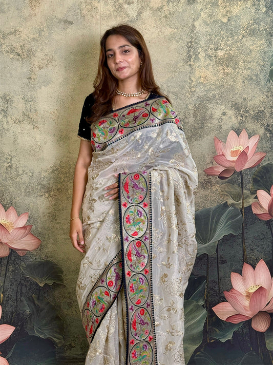Pure tissue silk saree with zari work and contrast fusion blouse and border.