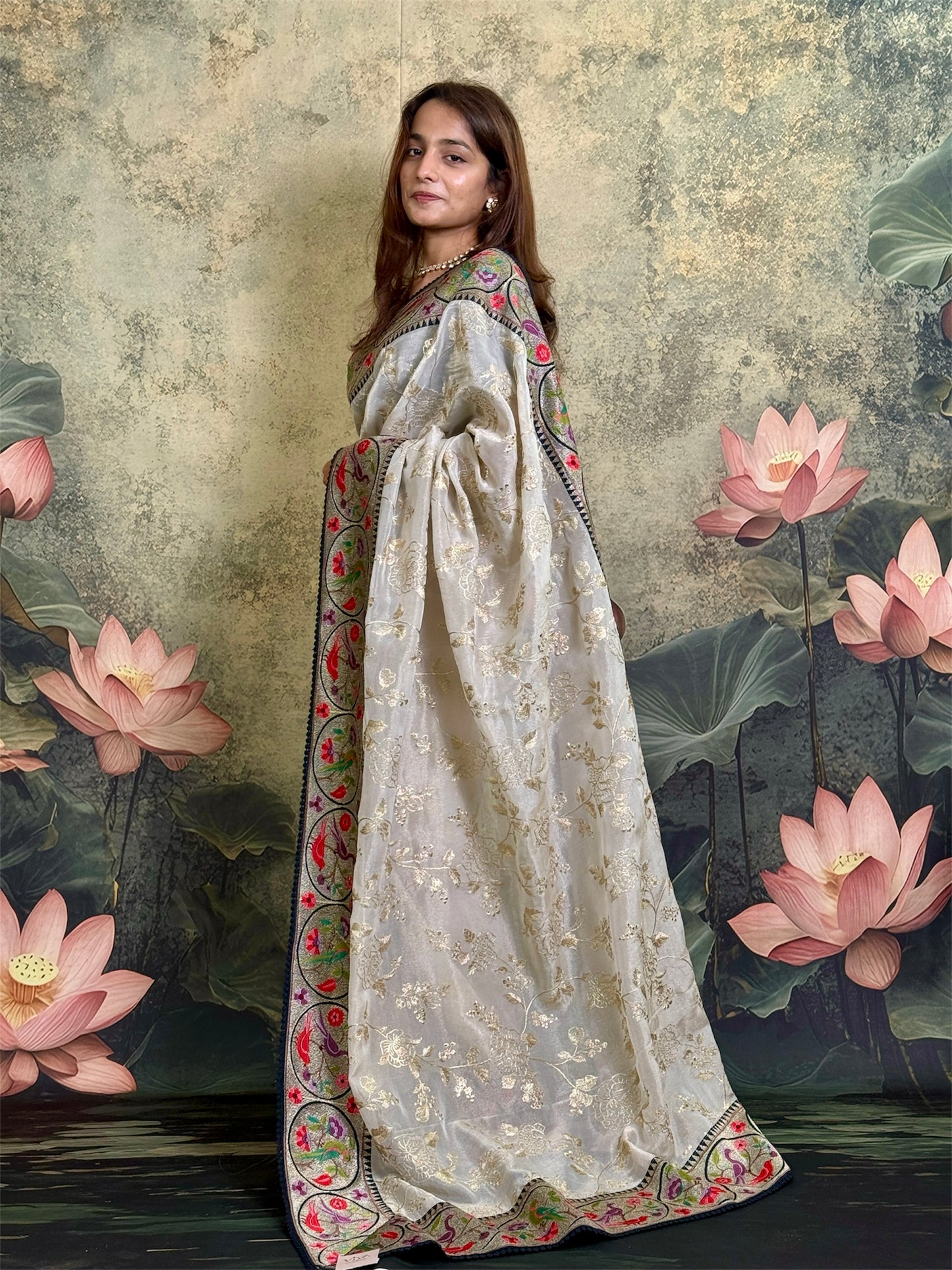 Pure tissue silk saree with zari work and contrast fusion blouse and border.