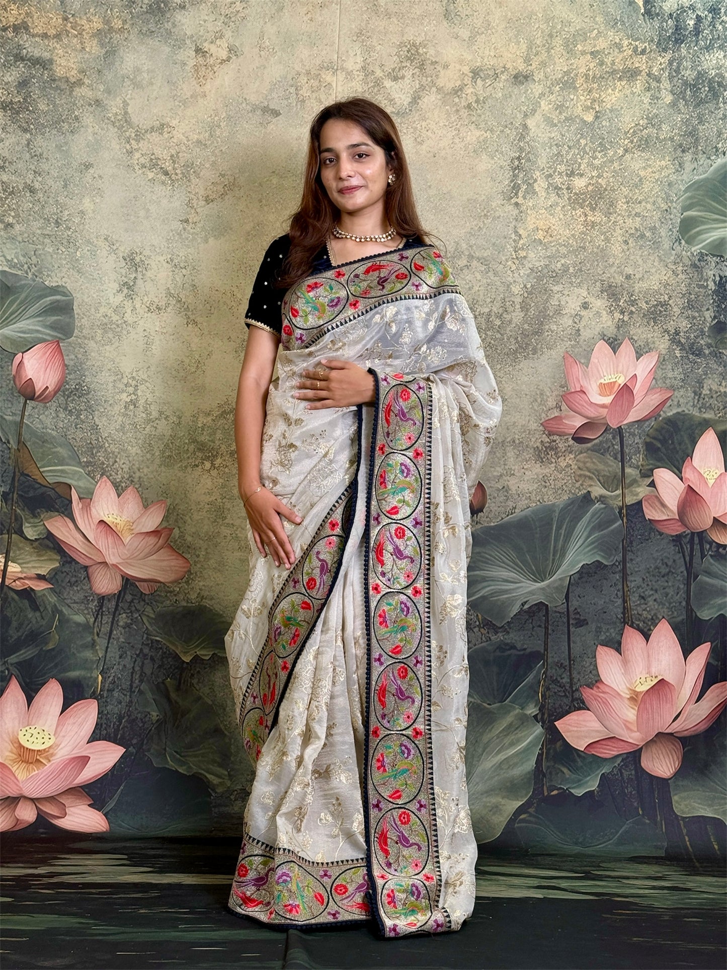Pure tissue silk saree with zari work and contrast fusion blouse and border.